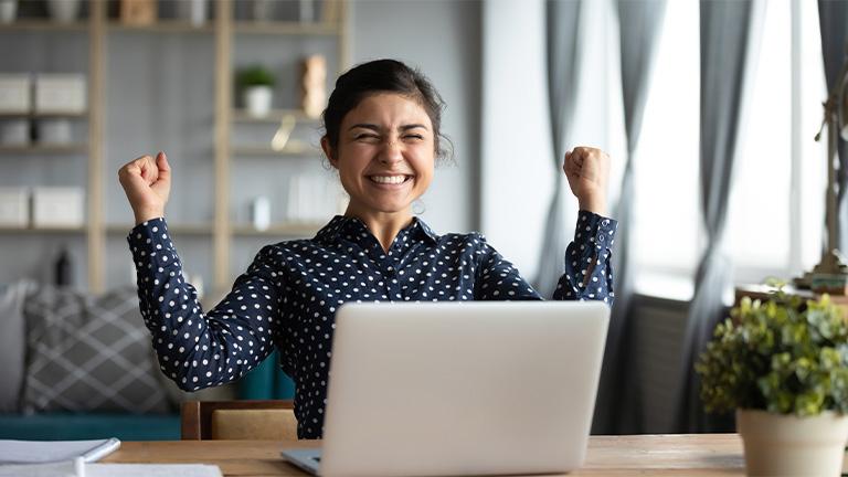 Woman at computer excited about her savings possibilities.